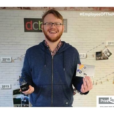 Me holding my 'Employee of the Month' award
